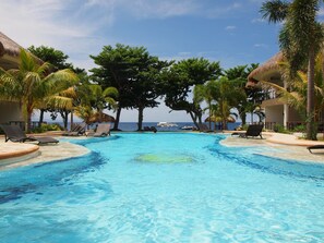 3 outdoor pools, open 6:00 AM to 10:00 AM, pool loungers - Vida Homes Condo Resort (Dauin)