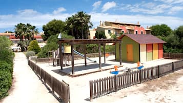 Children can play on a swing set, slide, and playhouse in this secure outdoor space.