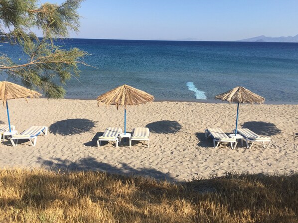 On the beach, sun loungers, beach umbrellas, beach towels