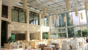 A spacious indoor dining area with high ceilings, large windows, and multiple tables and chairs. - Shuangyang Hotel (Huairou)