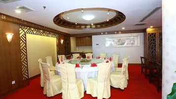 A conference room with a round table, chairs, and a red carpet.