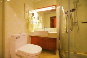 A bathroom with a toilet, sink, mirror, and shower. - Shuangyang Hotel (Huairou)