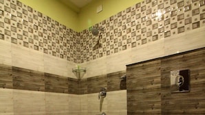 A bathroom with a shower, toilet, and tiled walls. - North Centre (Kanayannur)