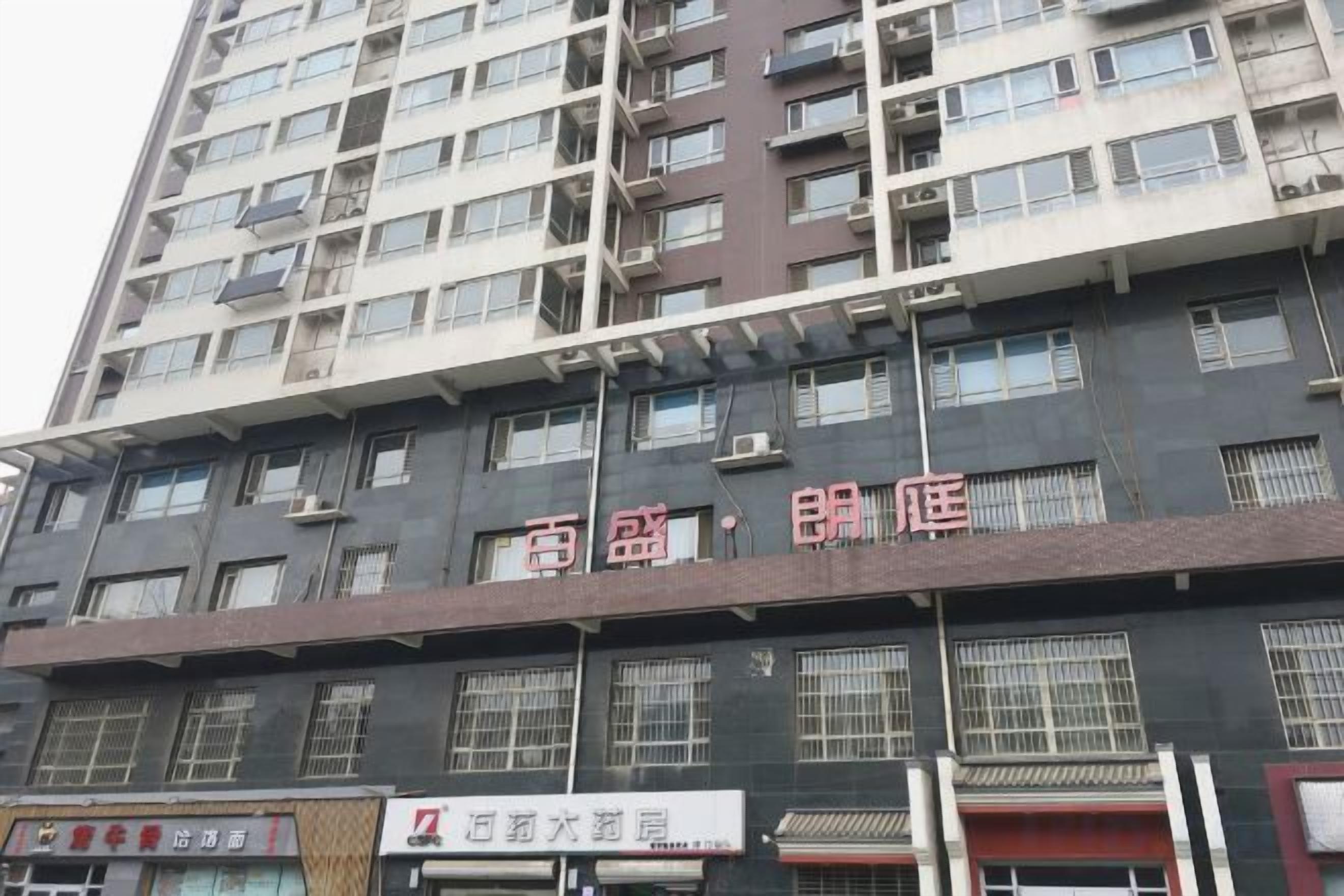 A multi-story building with a sign indicating a hotel.