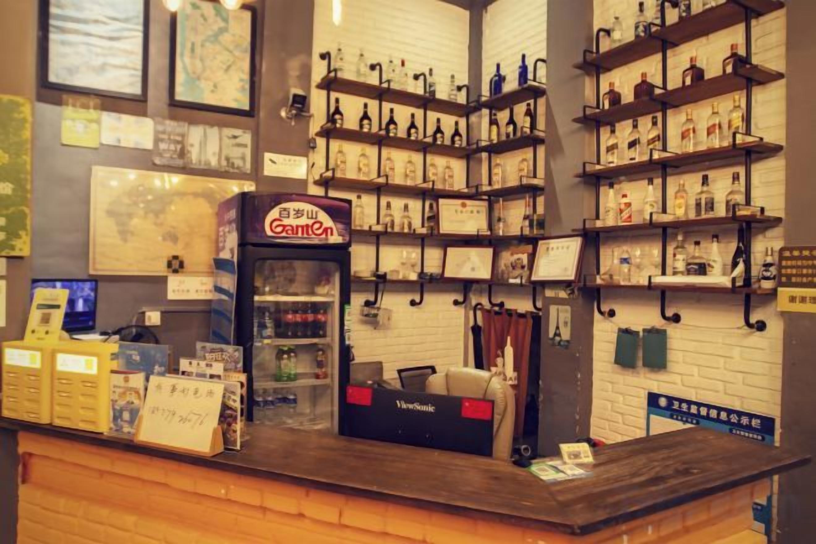 A counter with a vending machine, shelves with bottles, and a map on the wall.