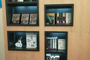 Four black-framed shelves with books and decorative items.