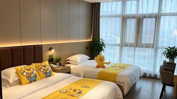 A hotel room with two beds, a nightstand, a lamp, a window with curtains, and a potted plant.