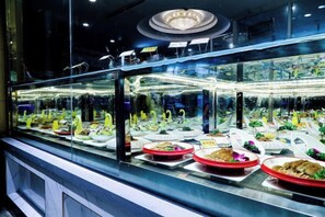 A buffet with various food items displayed in glass cases. - Jiehui Hotel (Shanghai)