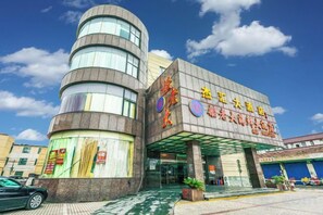A modern building with a curved facade and signage indicating it is a hotel. - Jiehui Hotel (Shanghai)