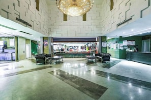 A lobby with a reception desk, seating area, and a chandelier. - Jiehui Hotel (Shanghai)