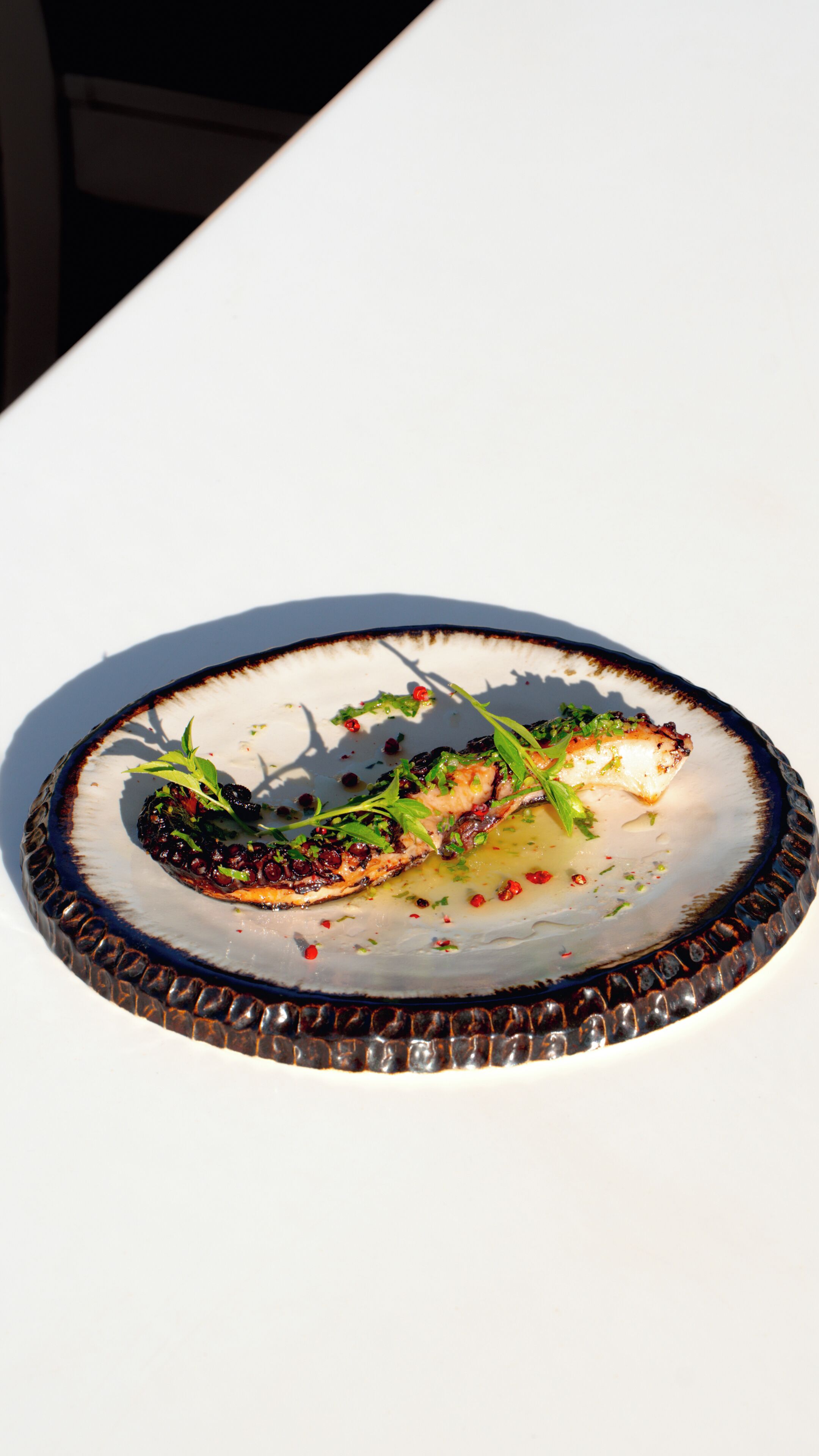 A plate with food on a white table.