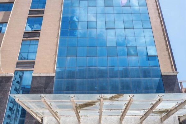 A high-rise building with a reflective glass facade.