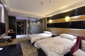 A hotel room with two beds, a desk, a TV, and a large mirror. - Minghao Hotel (Xianju)