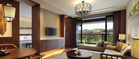 A hotel room with a balcony, a dining area, and a seating area with a view.