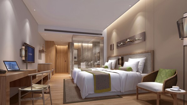 Quarto de hotel moderno com uma cama grande, uma escrivaninha e um computador portátil.