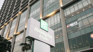 A hotel sign with the name 'Holiday Inn & Suites' indicating the establishment.