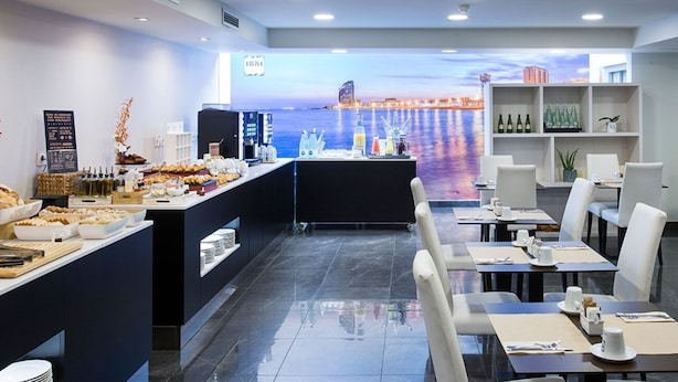 A restaurant with a buffet, seating area, and a view of the water. - 1881 Barcelona Rosellón Hotel (Barcelona)