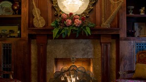A grand room with a large chandelier, a fireplace, and a mirror above it. - Boggs Mansion (Pittsburgh)