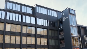 A modern building with multiple floors, large windows, and a prominent 'Landmark' sign. - The Landmark Hotel (Pikeville)