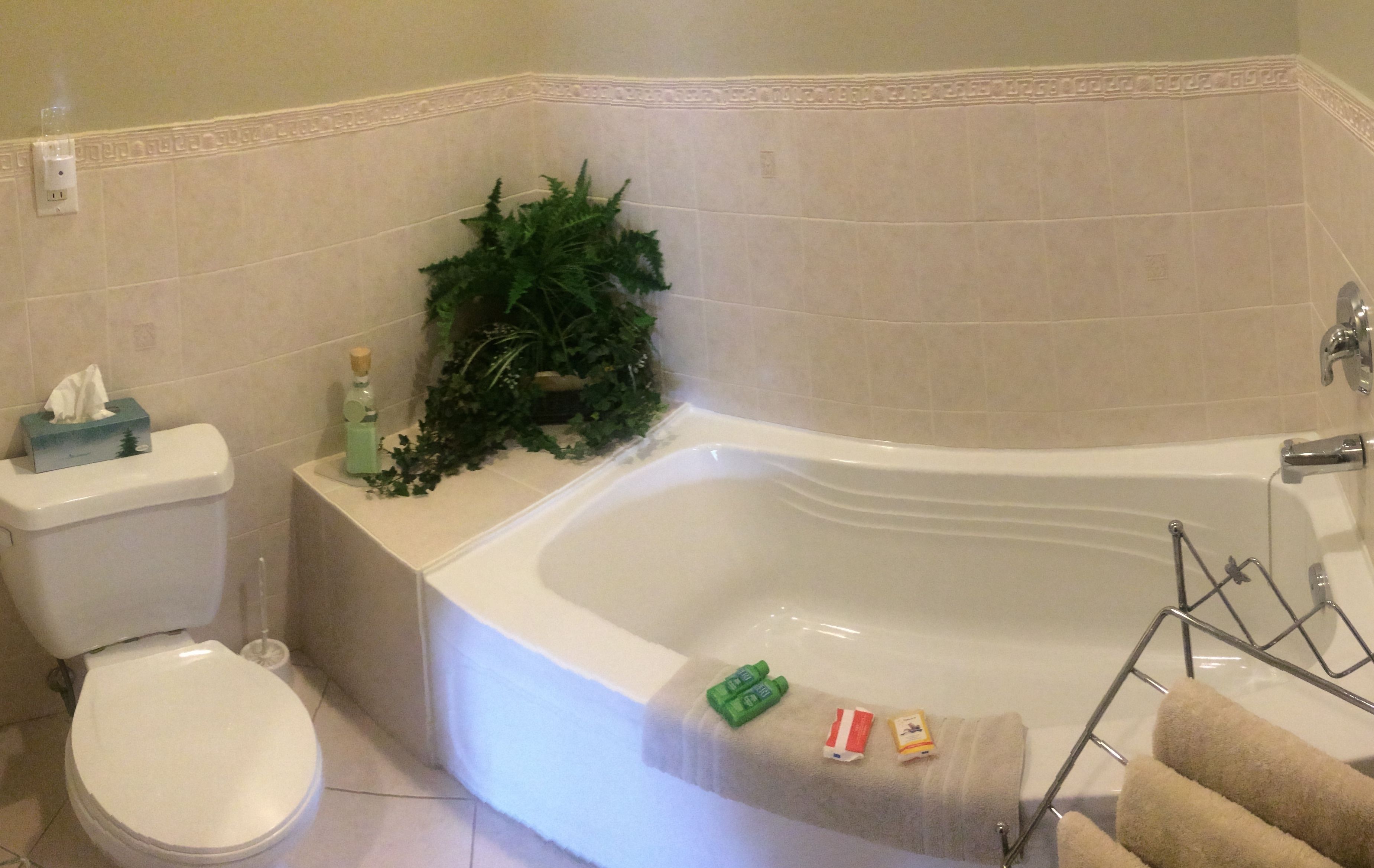 A bathroom with a toilet, a sink, a bathtub, and a towel rack.