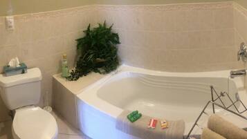 A bathroom with a toilet, a sink, a bathtub, and a towel rack.