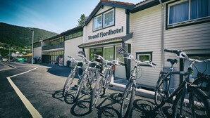 A building with a sign reading "Strand Fjordhotel" and several bicycles parked in front. - Strand Fjordhotel (Ulvik)