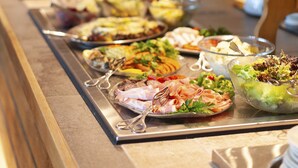 A buffet with various dishes and utensils. - Strand Fjordhotel (Ulvik)