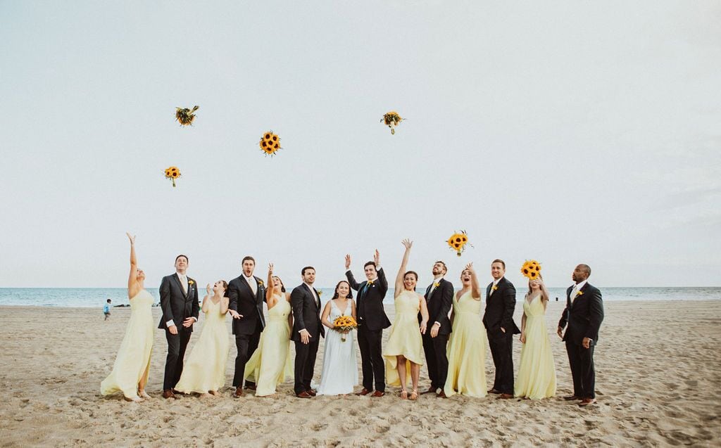 A group of people on a beach with a clear sky.