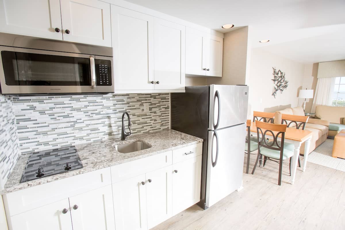 bi-level townhouse suite, 2 queen beds with sofa bed, kitchenette, ocean & pool view | private kitchen | fridge, microwave, coffee/tea maker