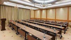 A conference room with long tables, water bottles, and a podium. - Zunyue Grace Hotel (Shanghai Lida University Branch) (Shanghai)