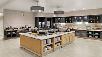 A modern kitchen with a central island, built-in appliances, and ample storage.