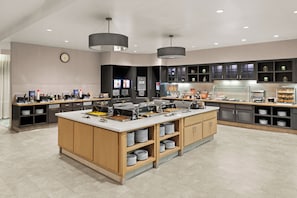 A modern kitchen with a central island, built-in appliances, and ample storage.