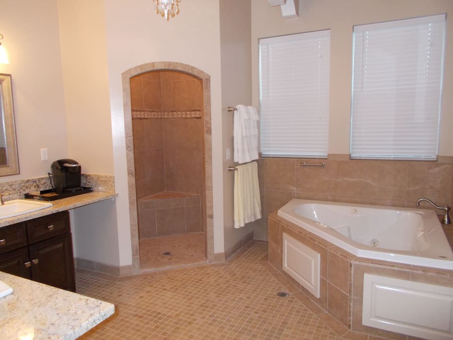 A bathroom with a shower, a bathtub, and a sink.