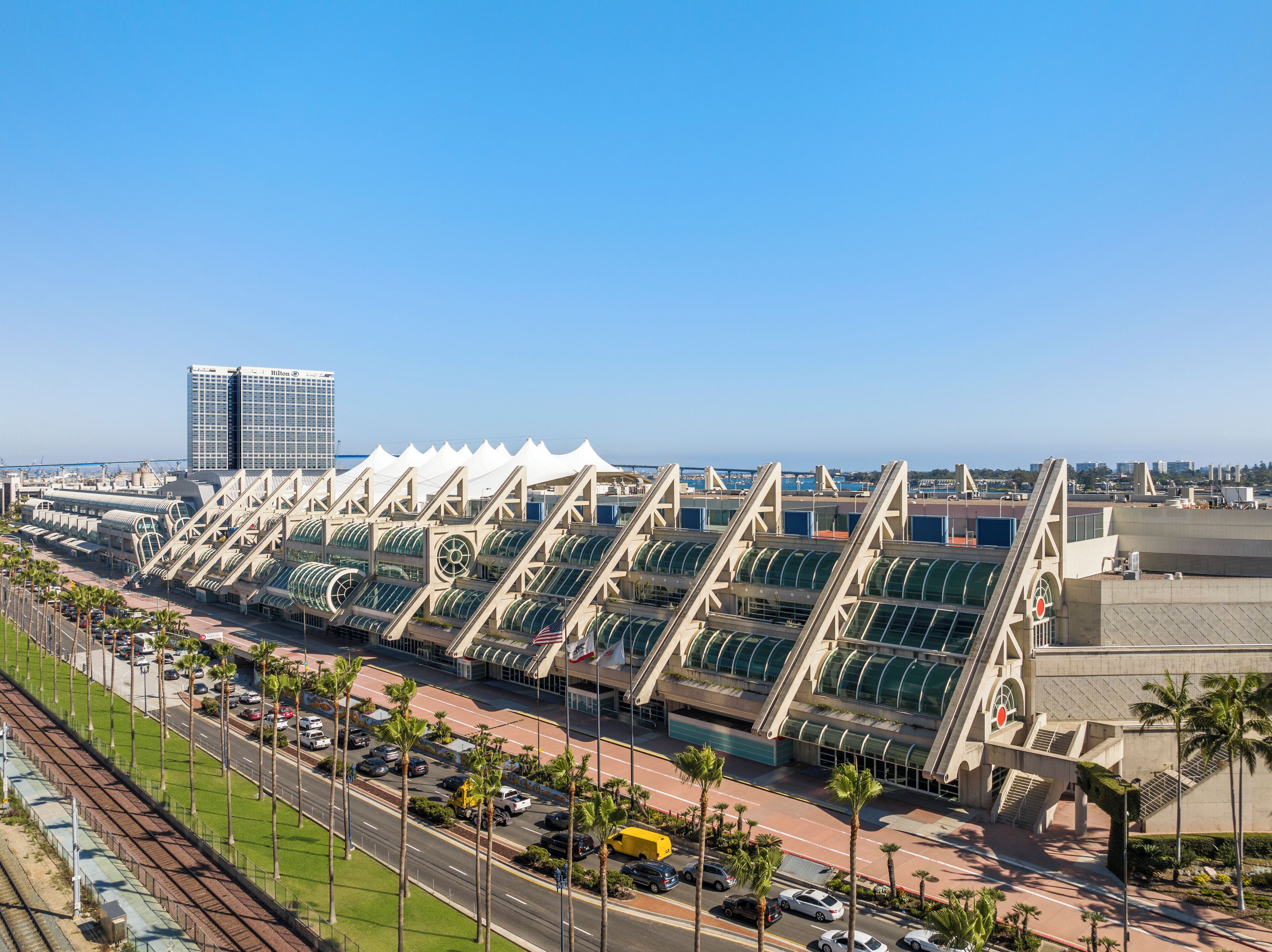 A modern hotel with a distinctive architectural design featuring a series of interconnected structures with green canopies.