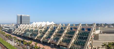 A modern hotel with a distinctive architectural design featuring a series of interconnected structures with green canopies.