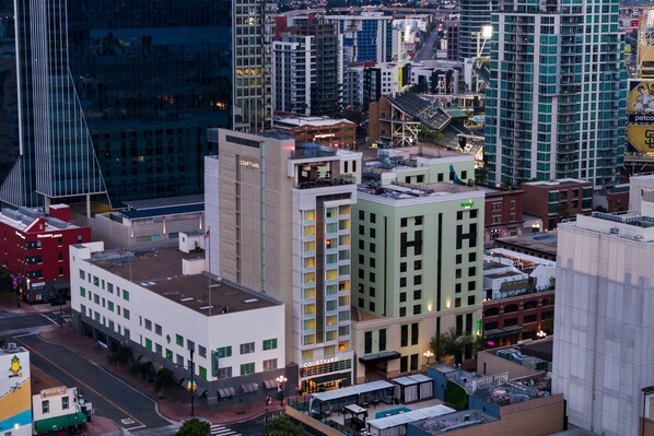 A Courtyard hotel with a modern design, located in a downtown area with surrounding high-rise buildings.