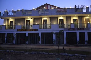 Un hôtel à plusieurs étages, doté de balcons et d’une enseigne indiquant « South Decor ».