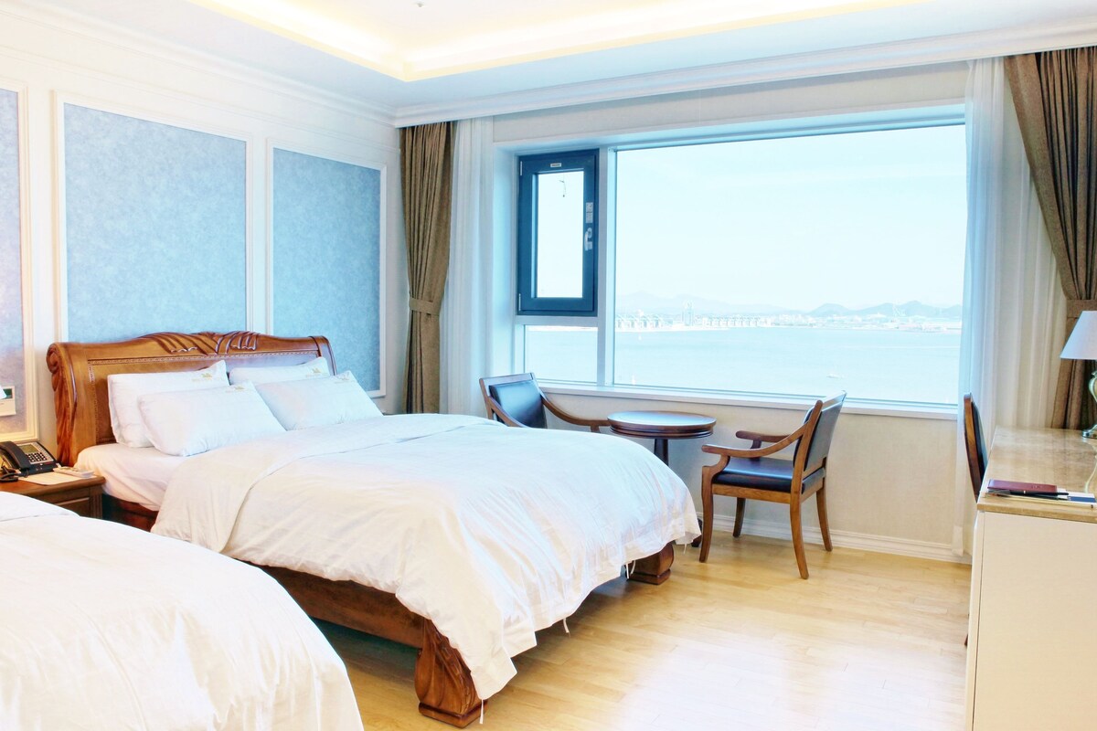 Premium bedding, desk, laptop workspace, blackout drapes
