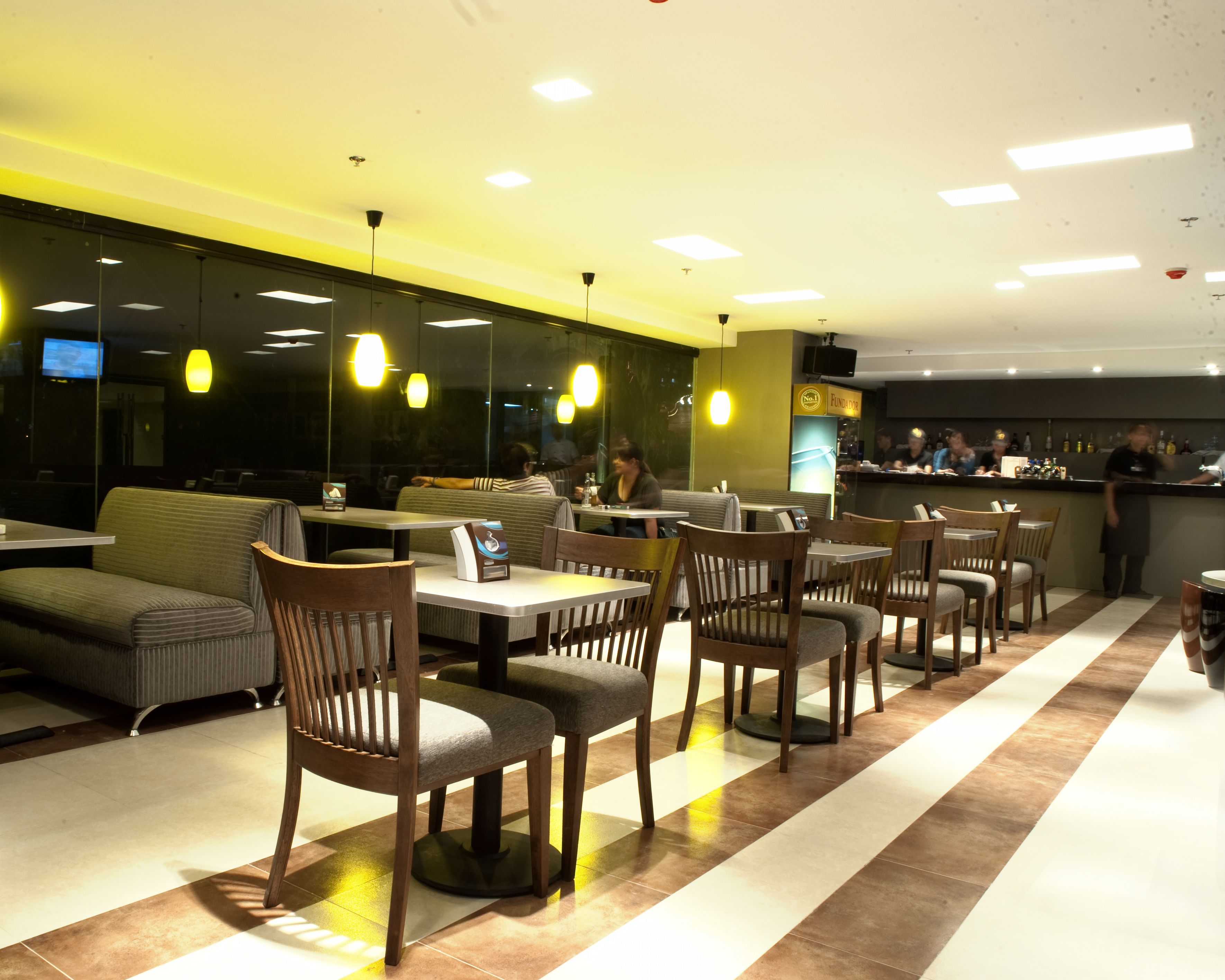 A restaurant interior with booths, tables, and chairs.