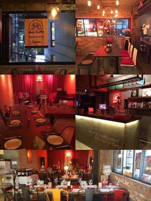 A restaurant interior with a cozy ambiance, featuring a bar area, dining tables, and a stage for live performances.