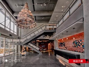A hotel lobby with a large chandelier, a staircase, and a reception desk. - No. 9 Hotel (Jiaoxi)