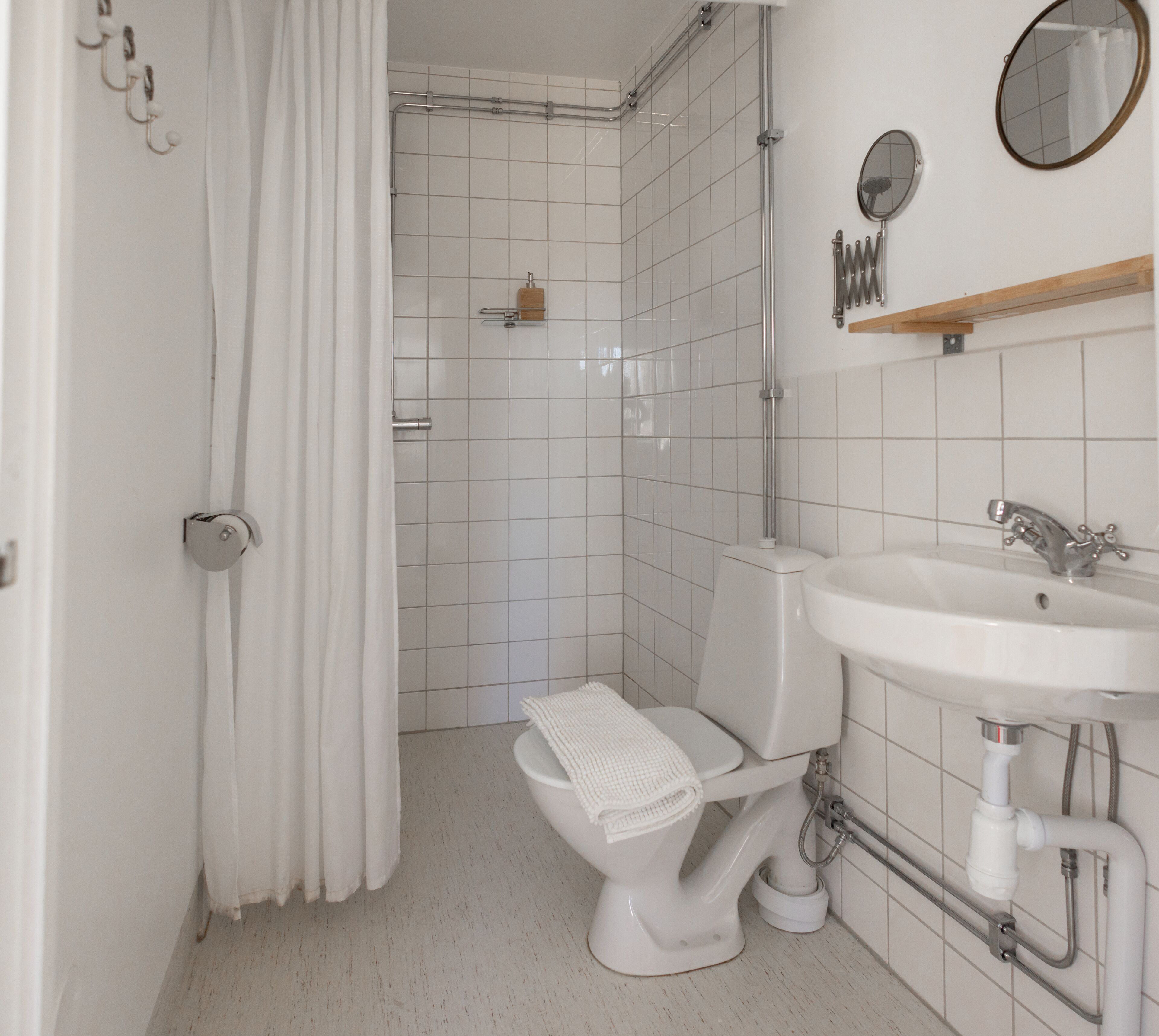 A bathroom with a toilet, sink, and shower.