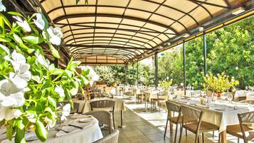 Enjoy a serene dining experience amidst lush greenery and beautiful gardens.