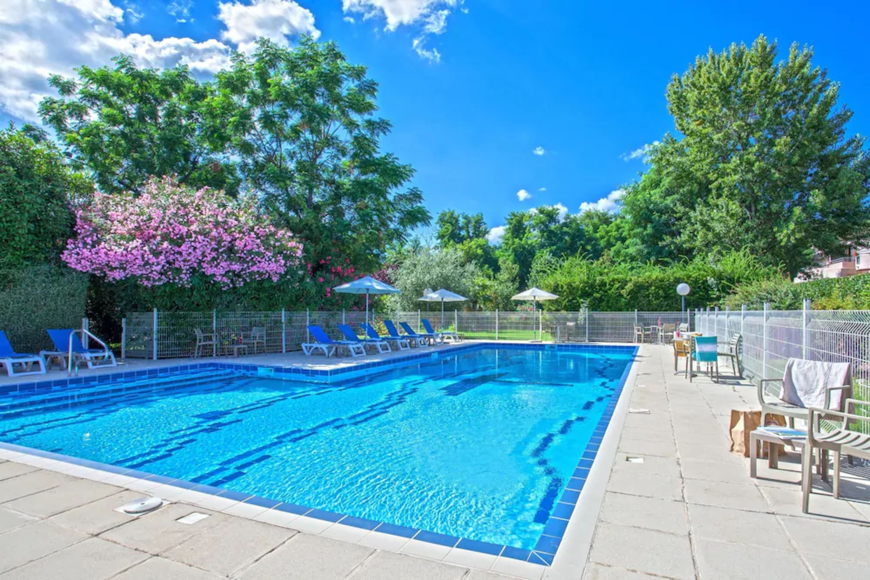 outdoor pool, open 7:30 am to 8:30 pm, pool loungers