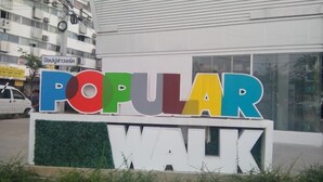 A sign with the word "POPULAR" in colorful letters and "WALK" below it.
