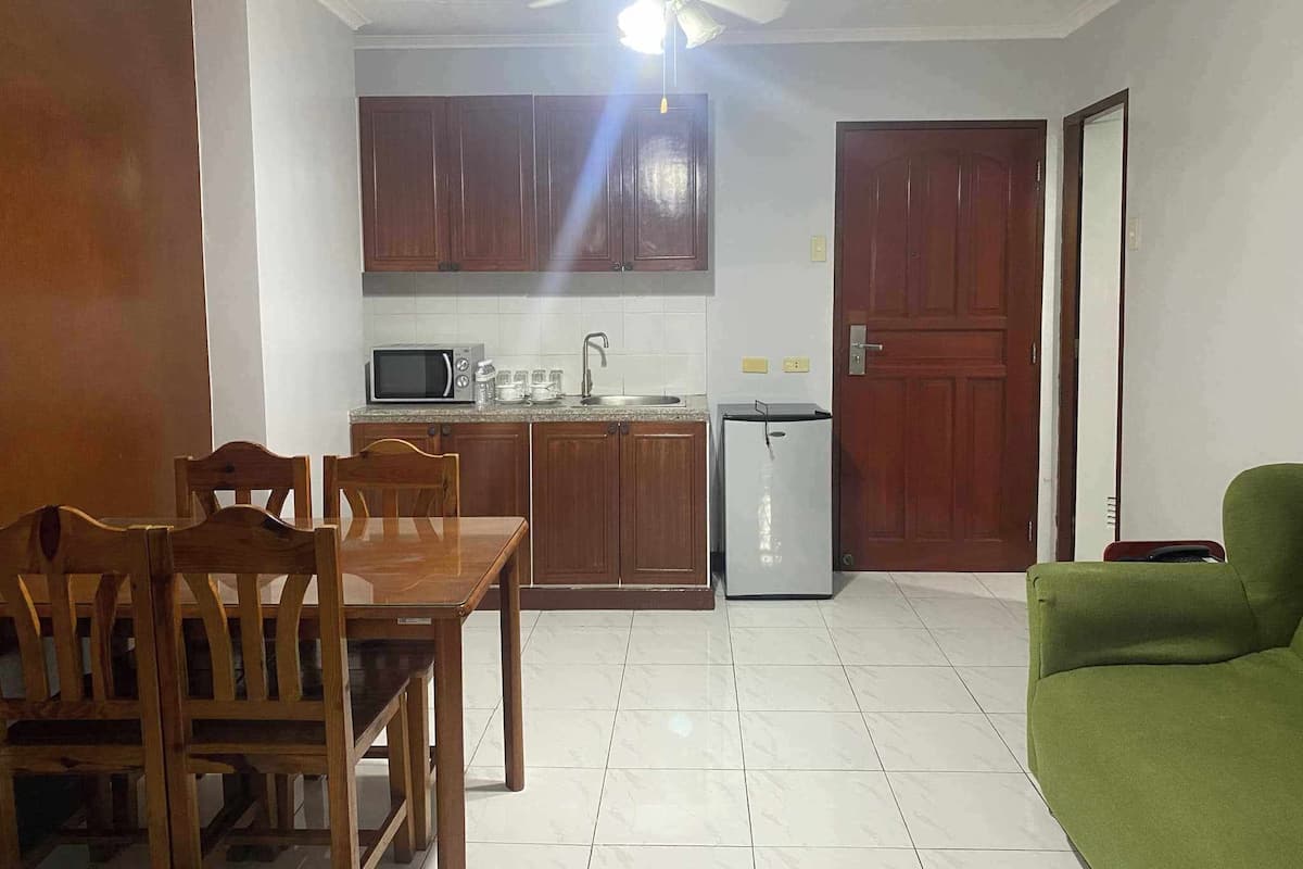 Family Suite | Living area | 25-inch LCD TV with cable channels, TV