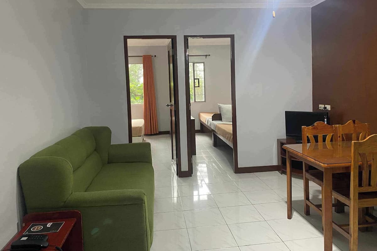 Family Suite | Living area | 25-inch LCD TV with cable channels, TV