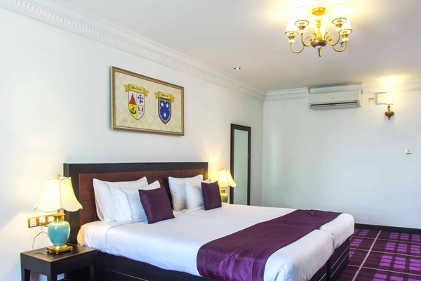 Deluxe Room, Courtyard View - Early check-in or late check-out subject to availability | Minibar, in-room safe, desk, iron/ironing board