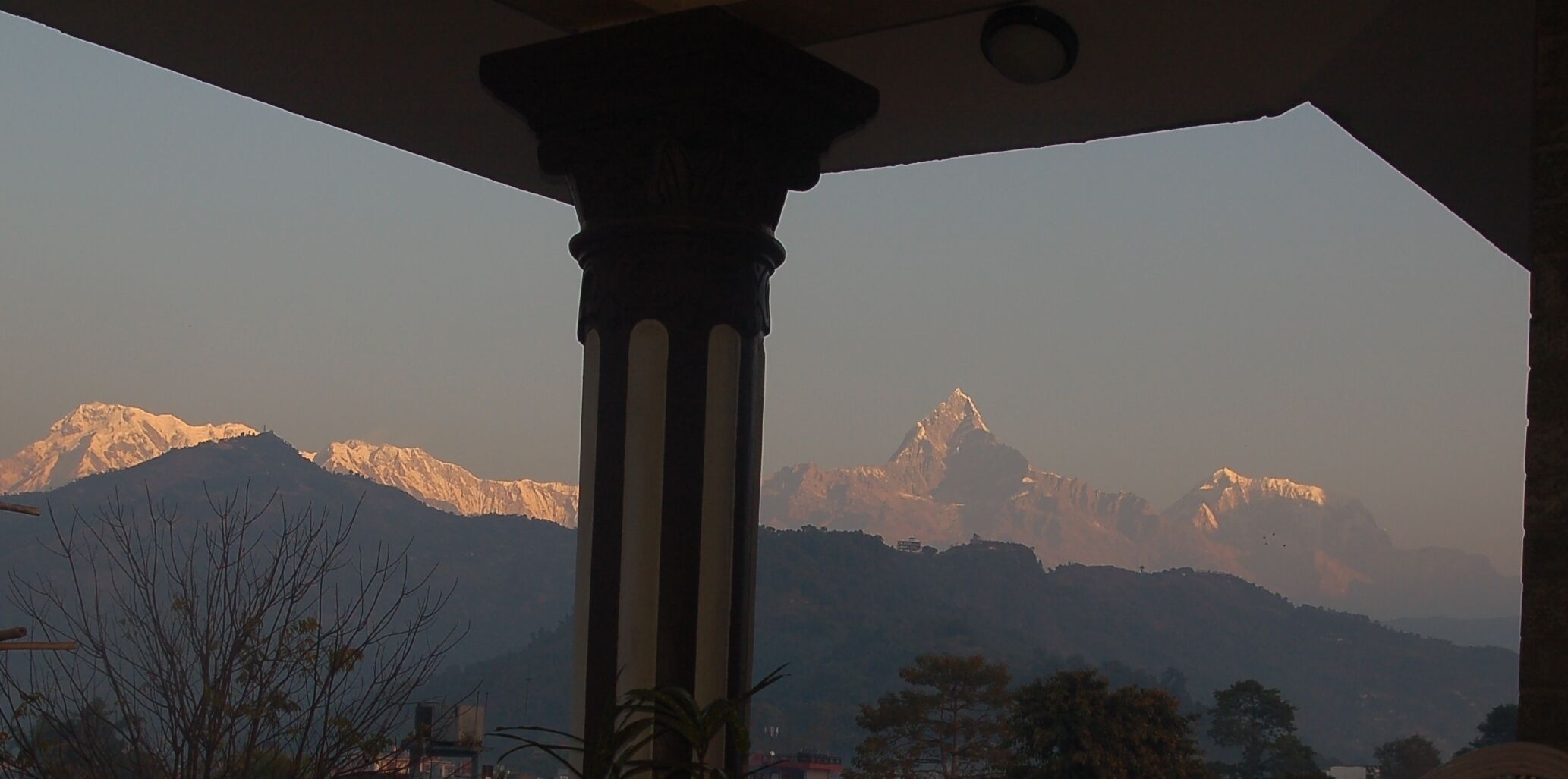 A mountain view with a column structure in the foreground.