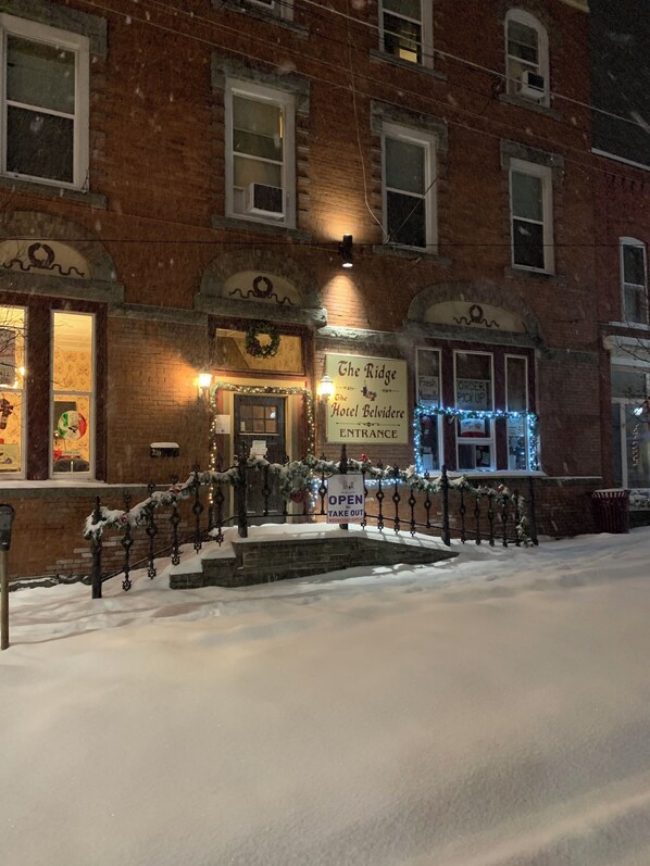 A brick building with a sign reading 'The Ridge Hotel Belvidere Entrance' and a 'Take Out' sign. - The Hotel Belvidere (Hawley)